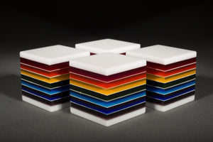 Fused, cut, and polished rainbow and white glass cubes