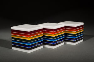 Fused, cut, and polished rainbow and white glass cubes