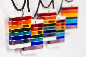 Fused, cut, and polished glass rainbow and white layer pendant