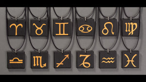Sandcarved gold and black glass zodiac pendants