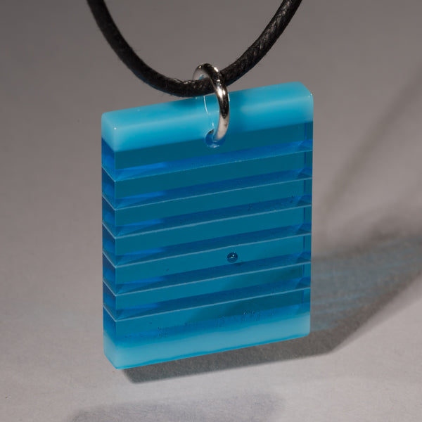 Cut and polished deep sky blue and turquoise glass pendant.