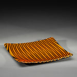 Sandcarved bright orange and black glass circle party plate.