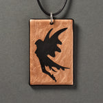 Sandcarved bronze and black glass fairy pendant.