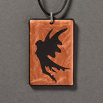Sandcarved copper and black glass fairy pendant.