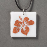 Sandcarved copper and white glass hibiscus flower pendant.