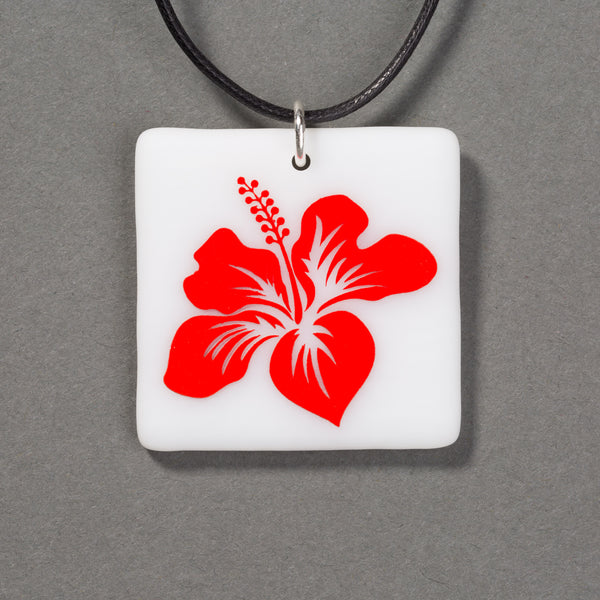 Sandcarved red and white glass hibiscus flower pendant.