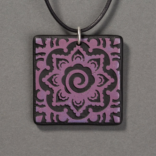 Sandcarved purple and black glass mehndi mandala pendant.