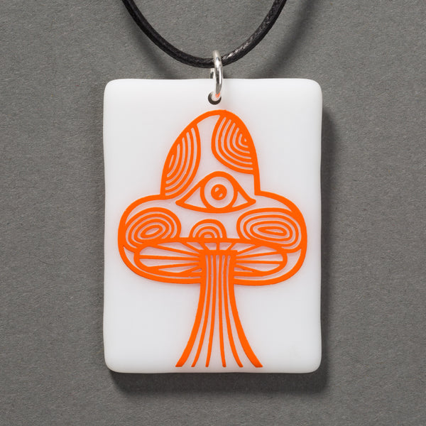 Sandcarved bright orange and white glass mushroom pendant.