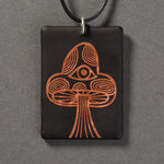 Sandcarved copper and black glass mushroom pendant.