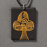 Sandcarved gold and black glass mushroom pendant.