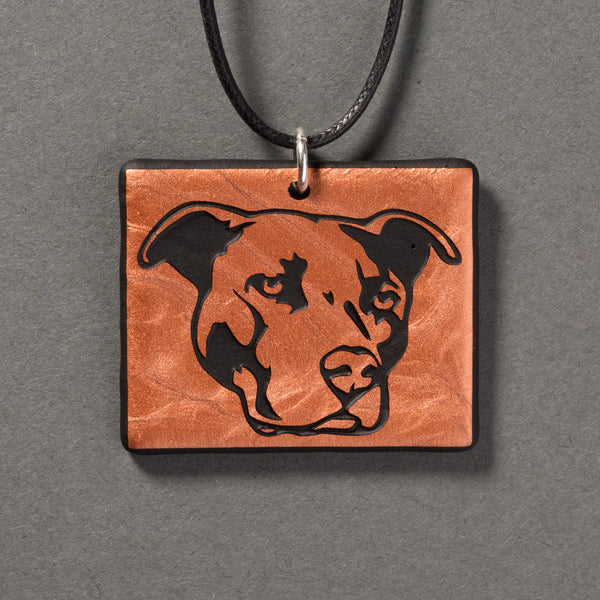Sandcarved copper and black glass pit bull pendant.