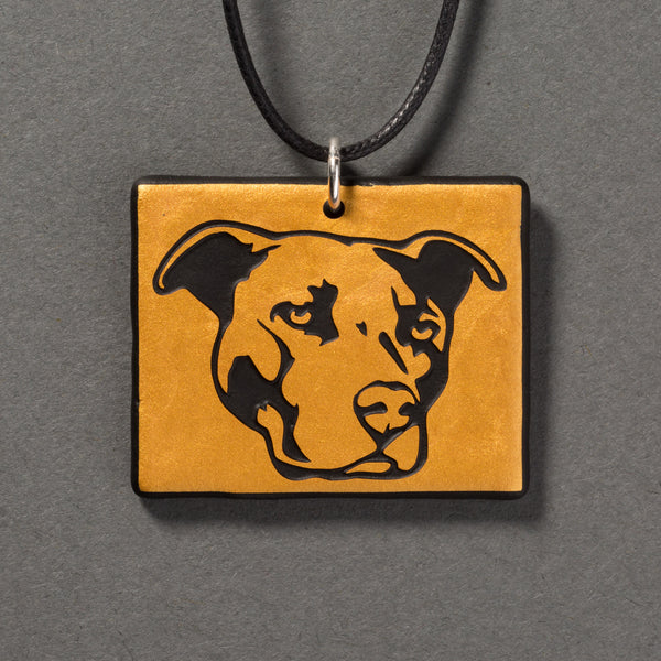 Sandcarved gold and black glass pit bull pendant.