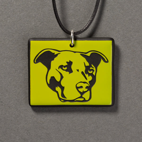 Sandcarved lime green and black glass pit bull pendant.
