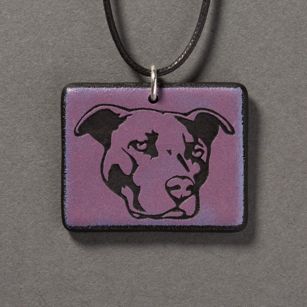 Sandcarved purple and black glass pit bull pendant.