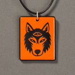 Sandcarved bright orange and black glass silicate wolf logo pendant.