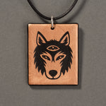 Sandcarved bronze and black glass silicate wolf logo pendant.