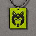 Sandcarved lime green and black glass silicate wolf logo pendant.
