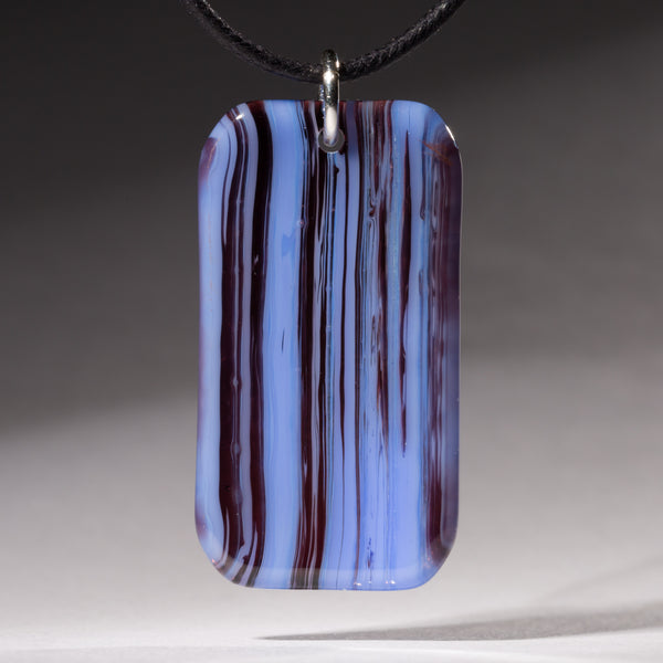 Fused blue and plum transparent glass streaky pendant.