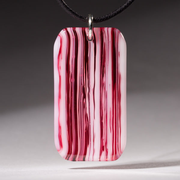Fused cranberry pink and white glass streaky pendant.