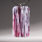 Fused royal purple, cranberry pink, and white glass streaky pendant.