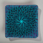 Sandcarved aquamarine and violet glass sun swimmer plate.