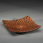 Sandcarved copper and black glass sun swimmer plate.