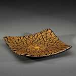 Sandcarved gold and black glass sun swimmer plate.