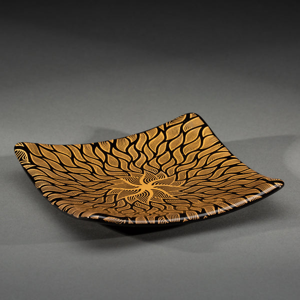 Sandcarved gold and black glass sun swimmer plate.