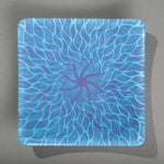 Sandcarved purple and cyan glass sun swimmer plate.