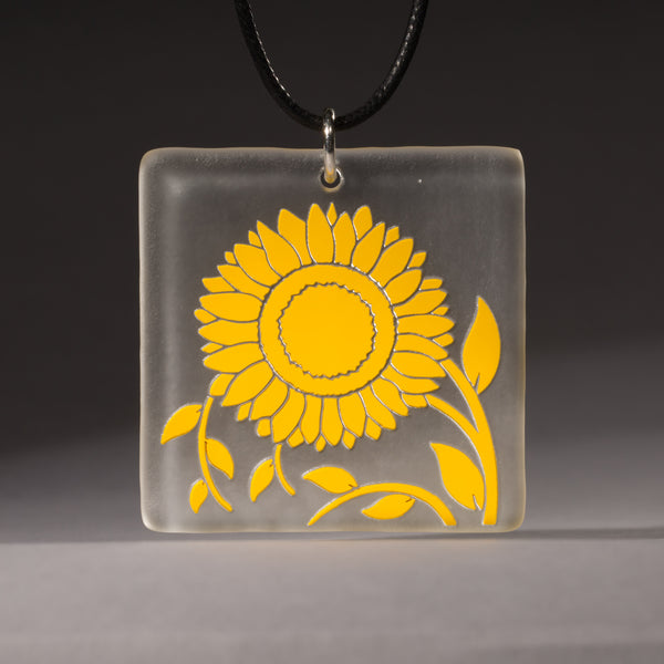 Sandcarved yellow and clear glass sunflower pendant.