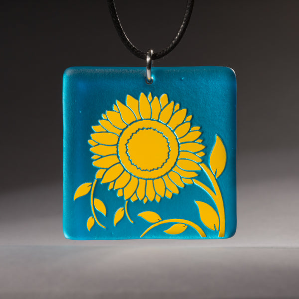 Sandcarved yellow and turquoise transparent glass sunflower pendant.