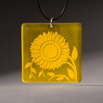 Sandcarved yellow and yellow transparent glass sunflower pendant.