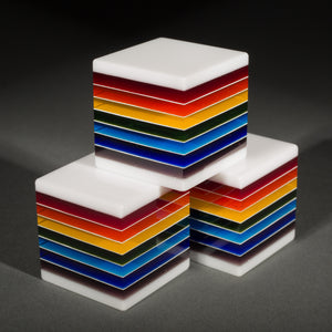 Fused, cut, and polished rainbow and white glass cubes