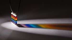 Fused, cut, and polished glass rainbow and white layer pendant