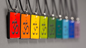 Sandcarved glass om pendants