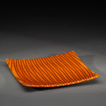 Sandcarved bright orange and brown glass circle party plate.