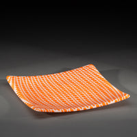 Sandcarved bright orange and white glass circle party plate.