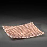 Sandcarved copper and white glass circle party plate.