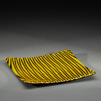 Sandcarved yellow and black glass circle party plate.