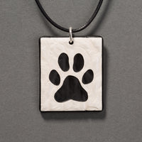 Sandcarved silver pearl and black glass dog paw pendant.