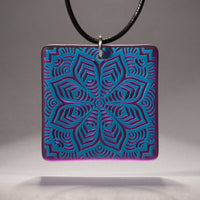 Sandcarved deep sky blue and violet transparent glass flower mandala pendant.