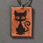 Sandcarved copper and black glass kitty pendant.