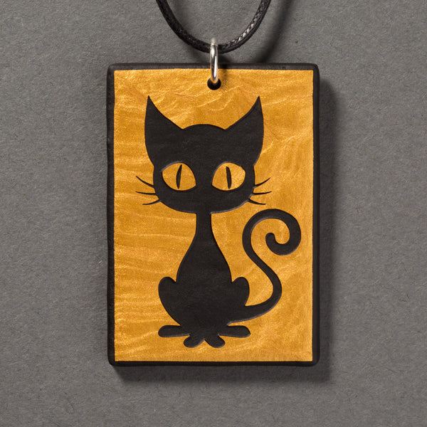 Sandcarved gold and black glass kitty pendant.