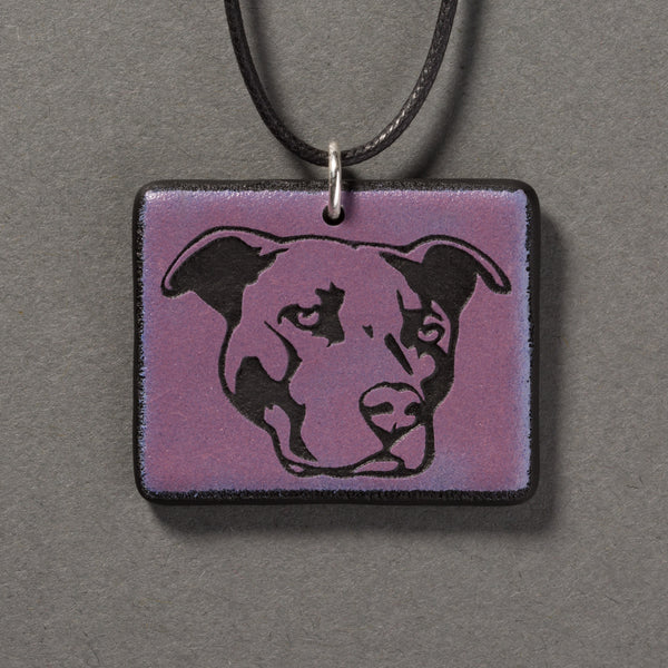 Sandcarved purple and black glass pit bull pendant.