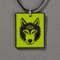 Sandcarved lime green and black glass silicate wolf logo pendant.