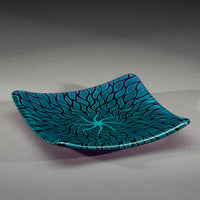 Sandcarved aquamarine and violet glass sun swimmer plate.