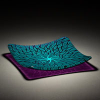Sandcarved aquamarine and violet glass sun swimmer plate.