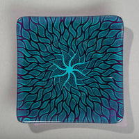 Sandcarved aquamarine and violet glass sun swimmer plate.