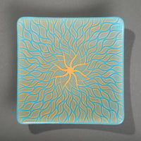 Sandcarved gold and cyan glass sun swimmer plate.