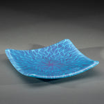 Sandcarved purple and cyan glass sun swimmer plate.